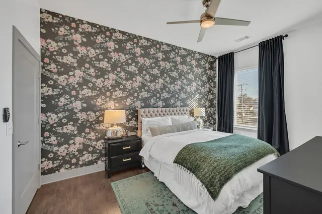 a bedroom with a bed dresser and a window