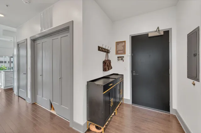 an empty room with wooden floor and cabinet