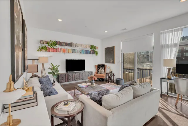 a living room with furniture flat screen tv and a fireplace