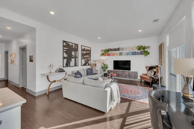 a living room with furniture fireplace and a window