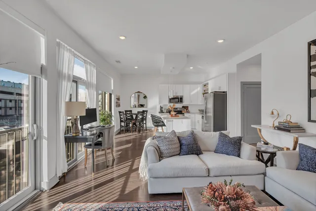 a living room with furniture white walls and a fireplace