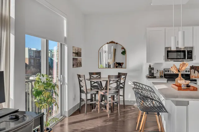 a view of a dining room with furniture window and wooden floor
