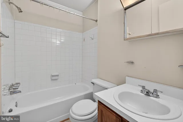 a bathroom with a sink a toilet and bathtub