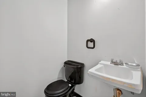 a bathroom with a sink toilet and mirror