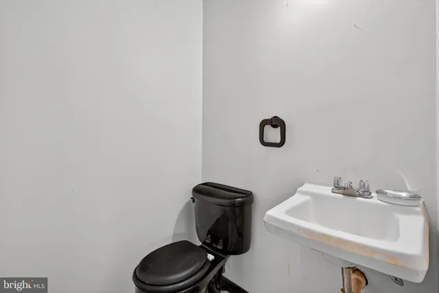 a bathroom with a sink toilet and mirror