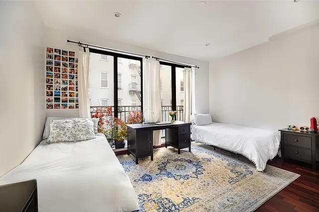 a bedroom with a large bed and a window