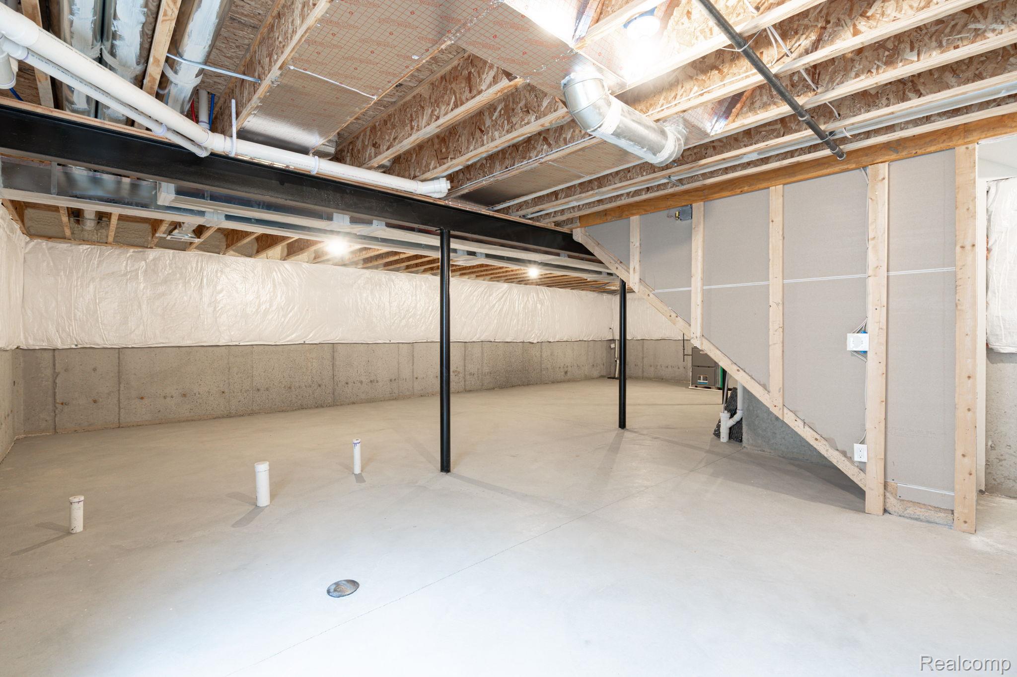 48904 Carnegie Way Macomb, MI 48042 - Photo 32 of 34 Expansive unfinished basement featuring concrete flooring, exposed joists, ductwork, and plumbing