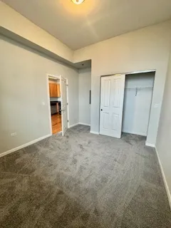 an empty room with a cabinet and mirrors