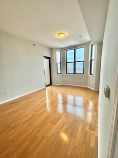 1464 South Michigan Avenue, Unit 2007 Chicago, IL 60605 - Photo 5 of 22 a view of empty room with wooden floor and fan