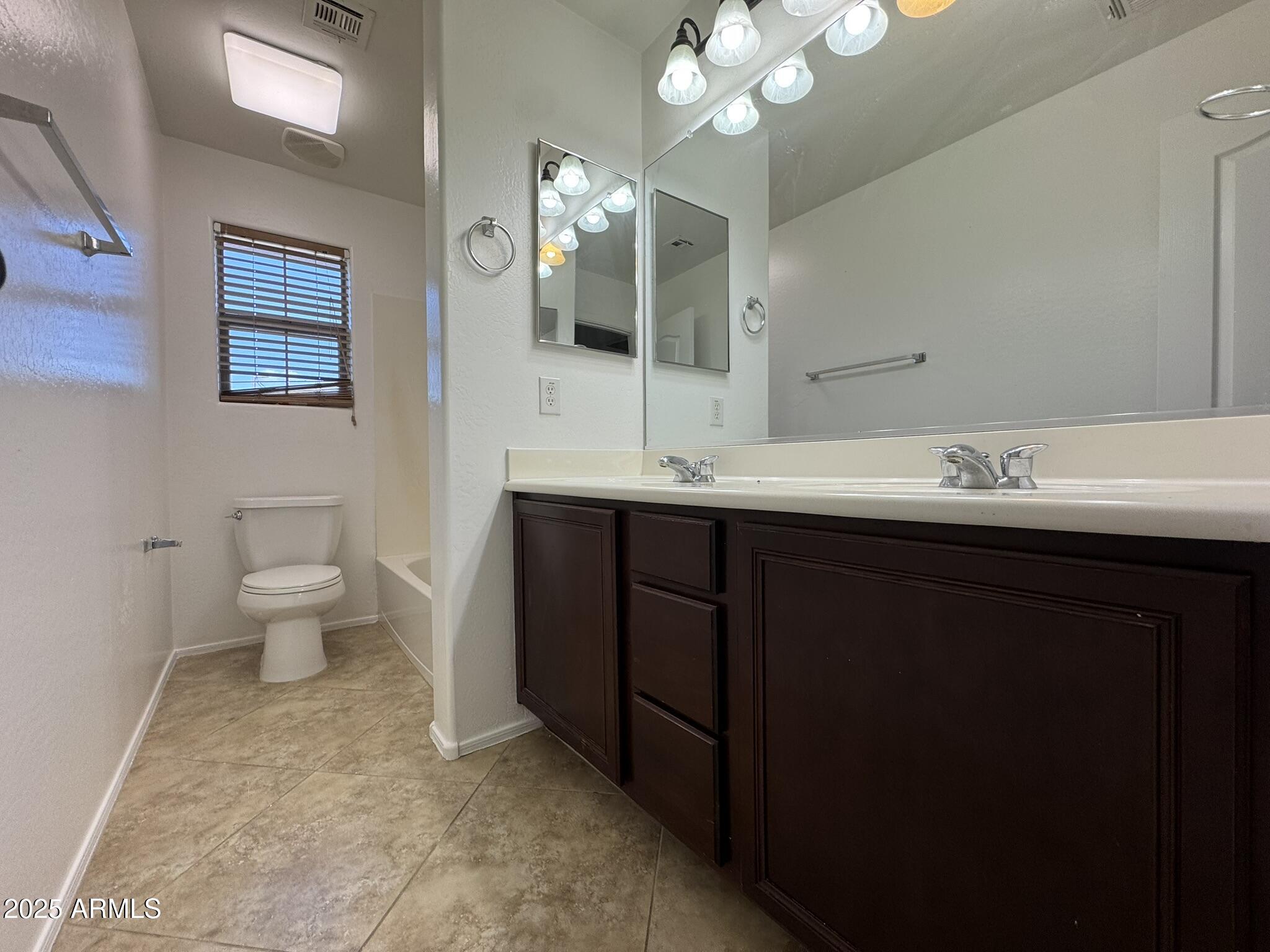 2311 West Hunter Court Phoenix, AZ 85085 - Photo 14 of 24 a bathroom with a sink a toilet and a mirror