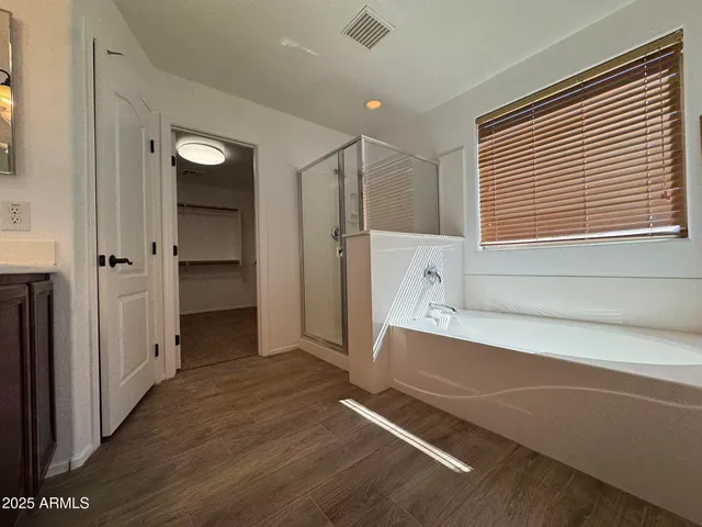 a bathroom with a bathtub and a shower