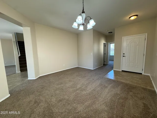 a view of a chandelier in big room and chandelier