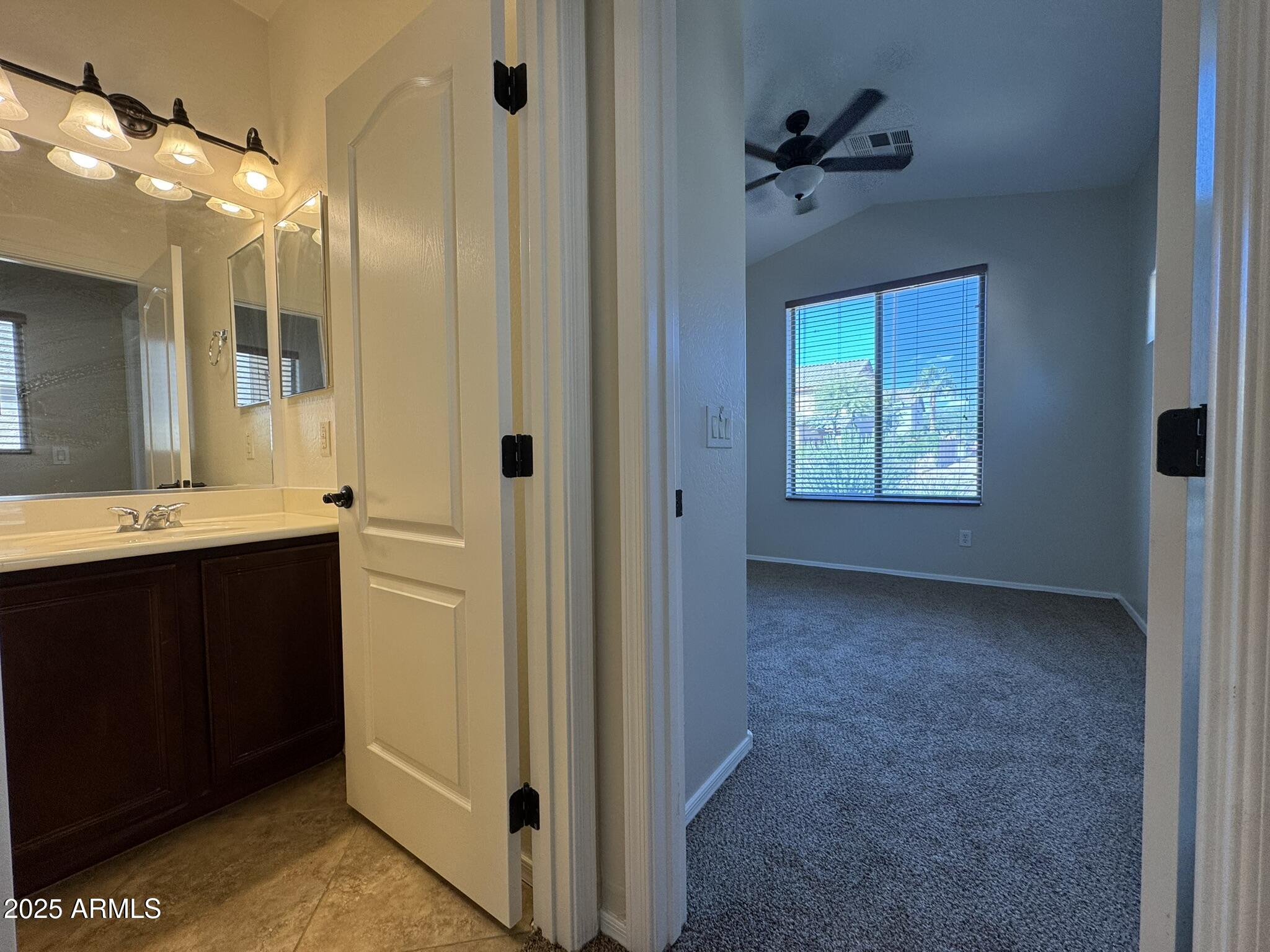 2311 West Hunter Court Phoenix, AZ 85085 - Photo 4 of 24 a bathroom with a sink and a mirror