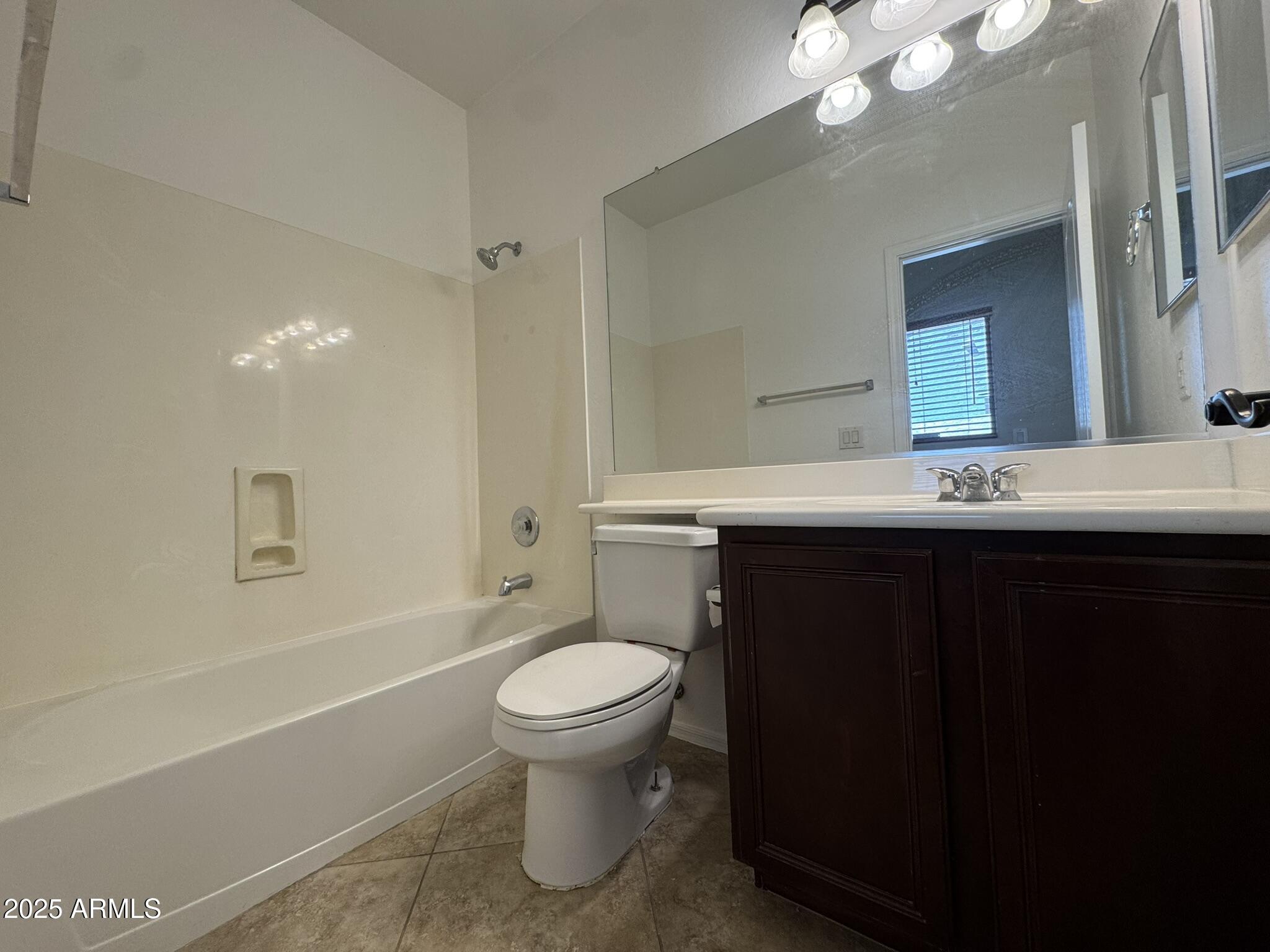 2311 West Hunter Court Phoenix, AZ 85085 - Photo 6 of 24 a bathroom with a sink toilet and shower
