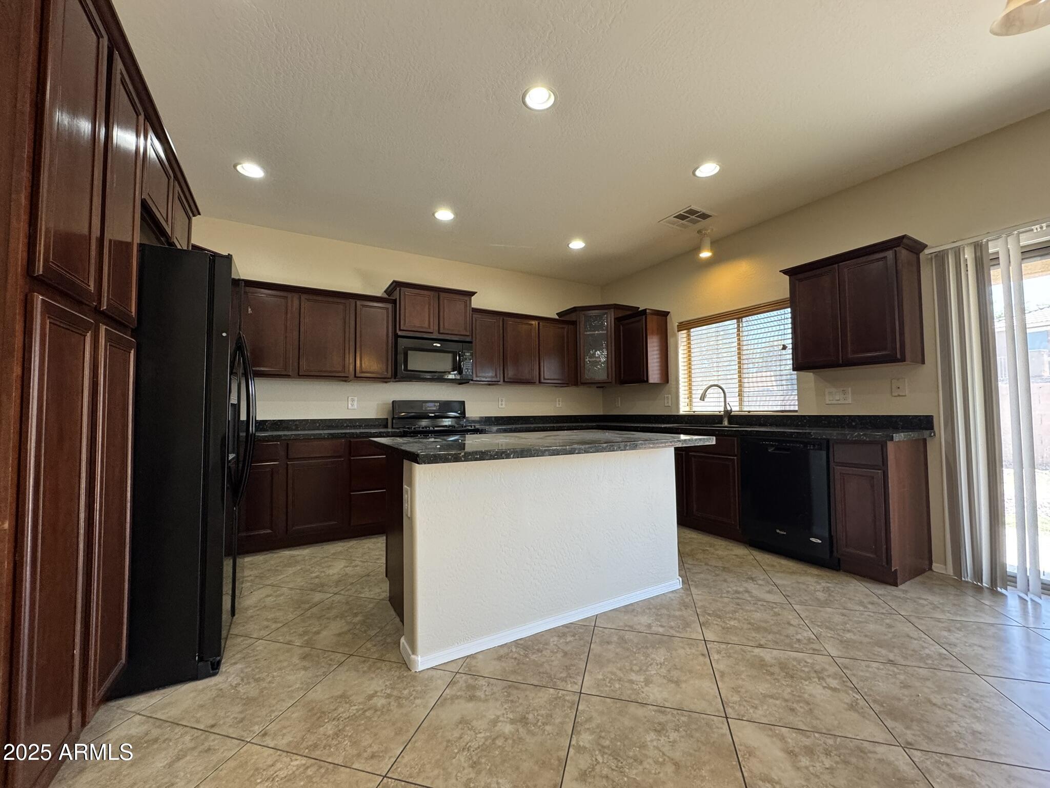 2311 West Hunter Court Phoenix, AZ 85085 - Photo 7 of 24 a kitchen with stainless steel appliances granite countertop a refrigerator and a sink