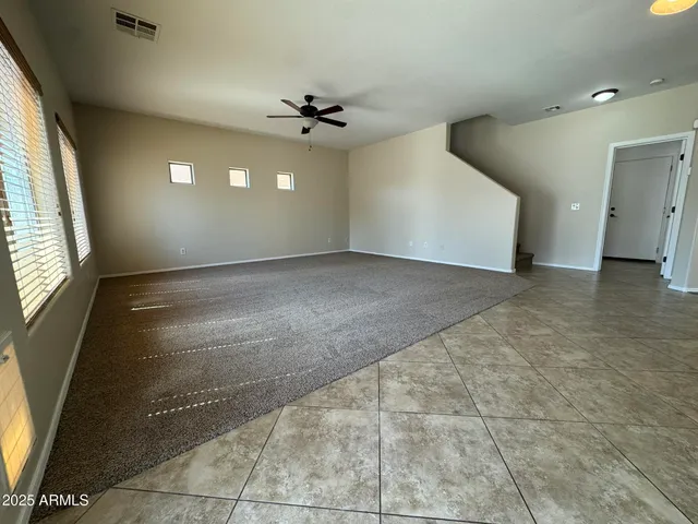 a view of a livingroom with a ceiling fan and window