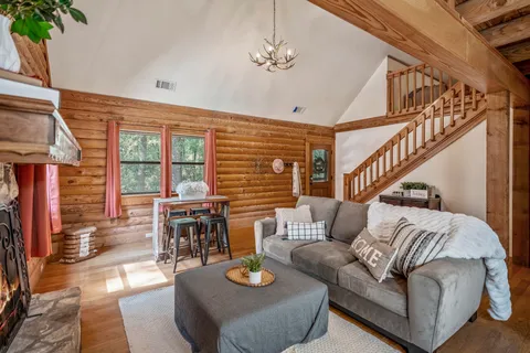 a living room with furniture fireplace and a large window