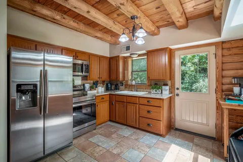 a kitchen with stainless steel appliances granite countertop a refrigerator a sink and dishwasher
