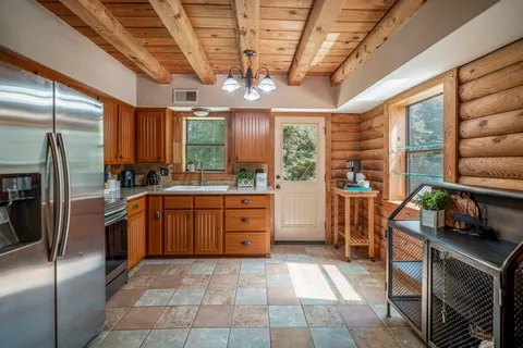 a kitchen with stainless steel appliances granite countertop a stove a refrigerator a sink and dishwasher
