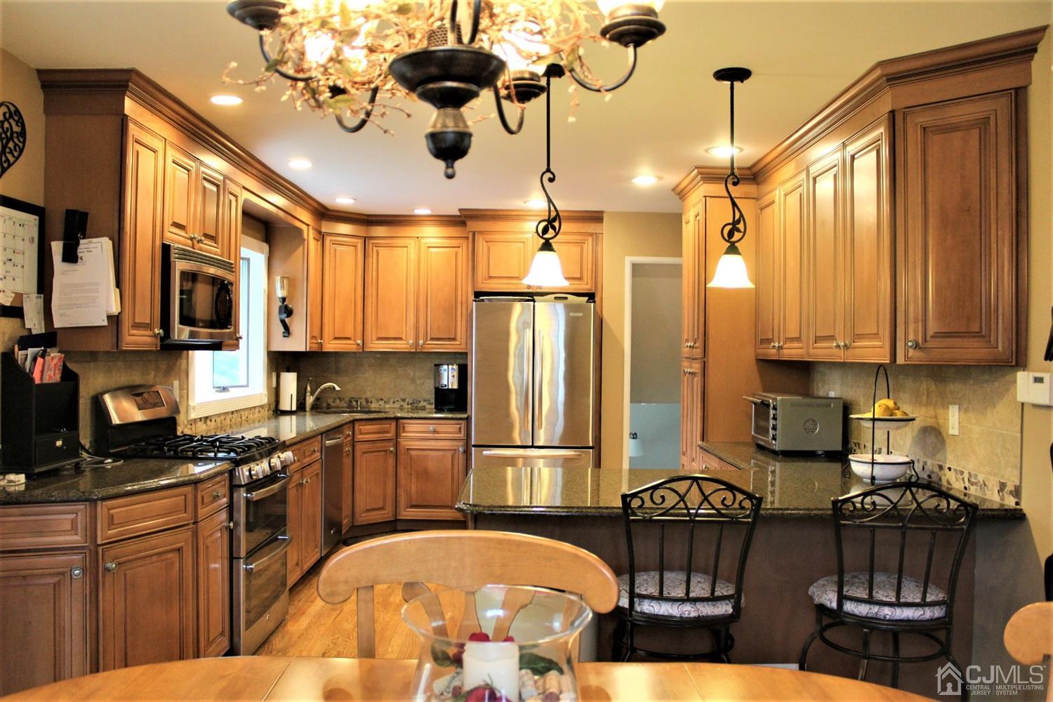 5 Golf Road Edison, NJ 08820 - Photo 14 of 45 a kitchen with stainless steel appliances granite countertop a stove refrigerator and microwave