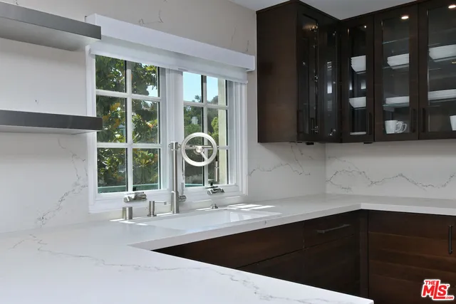 a bathroom with a sink and a large mirror