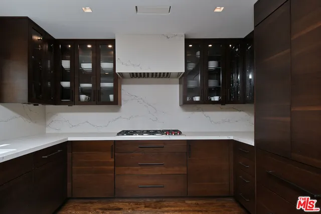 a kitchen with granite countertop cabinets and window