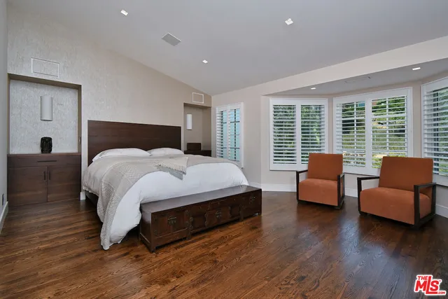 a bedroom with furniture and wooden floor