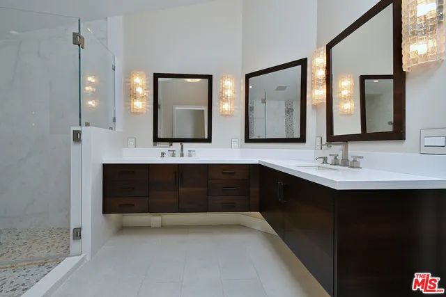 a bathroom with a sink a large mirror and vanity