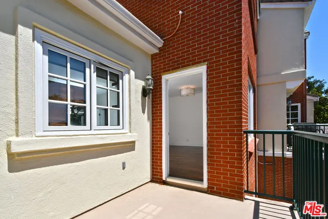 a view of a balcony with a potted plant