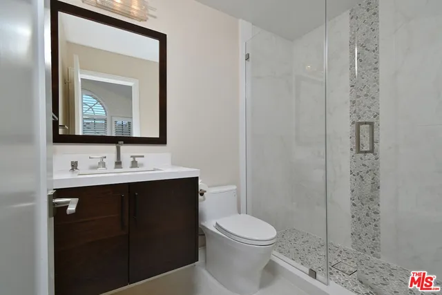 a bathroom with a toilet and a shower