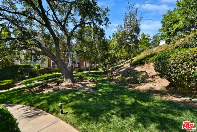 an aerial view of residential houses with outdoor space and mountain view