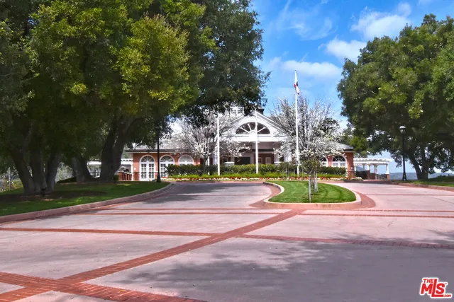 an aerial view of residential houses with yard and lake view