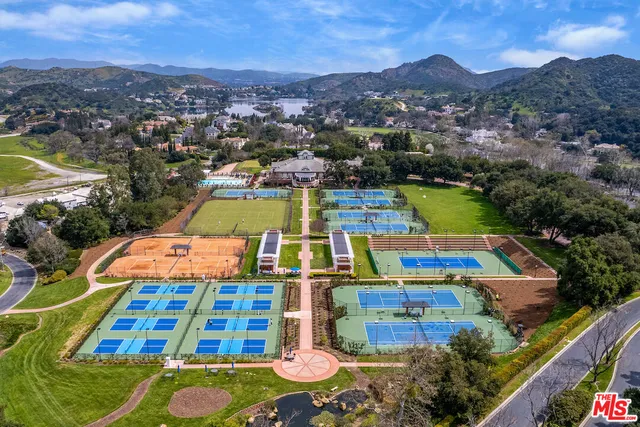 a front view of a house with a yard and fountain in middle