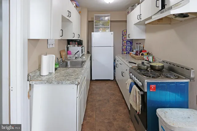 a kitchen with a sink a stove and refrigerator
