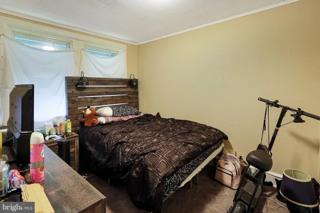 a bedroom with a bed and dresser