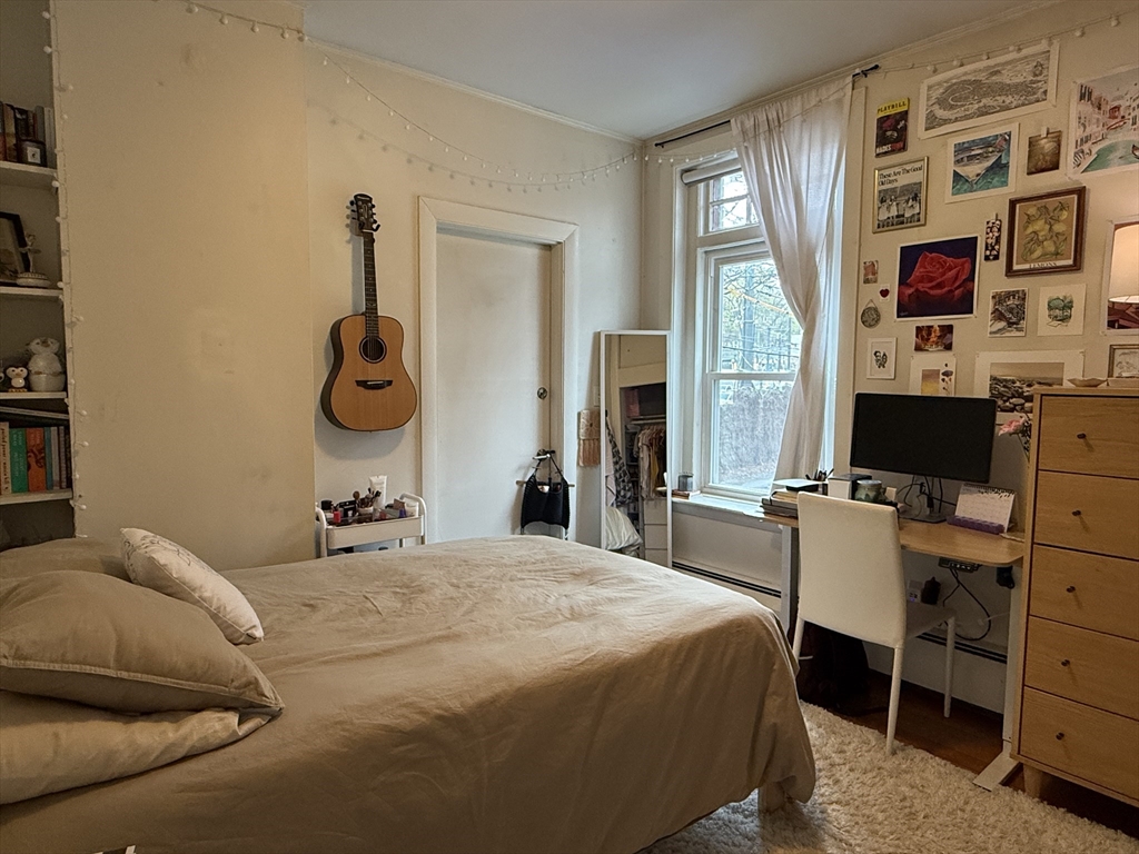 1871 Beacon Street, Unit 4 Brookline, MA 02445 - Photo 10 of 14 a bedroom with a bed and wooden floor