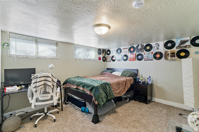 386 North 500 East Provo, UT 84606 - Photo 13 of 24 Bedroom with a textured ceiling, light carpet, and an office area