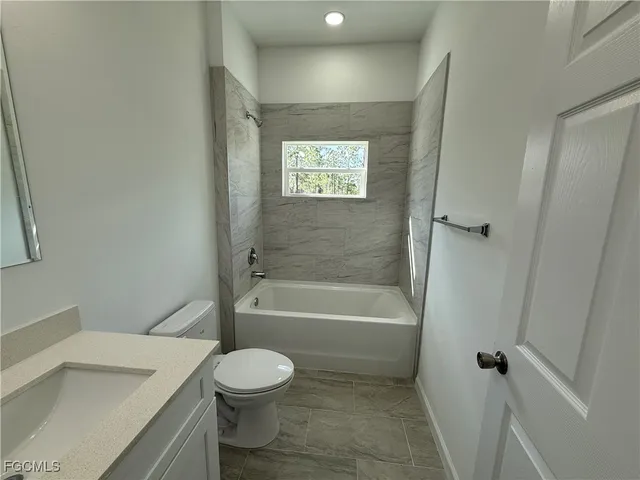 a bathroom with a toilet a sink and bathtub
