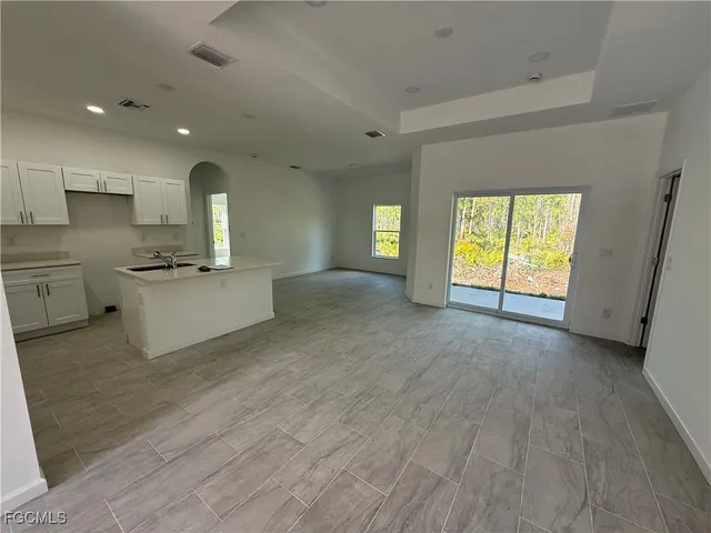 a view of a kitchen with a sink and a fireplace