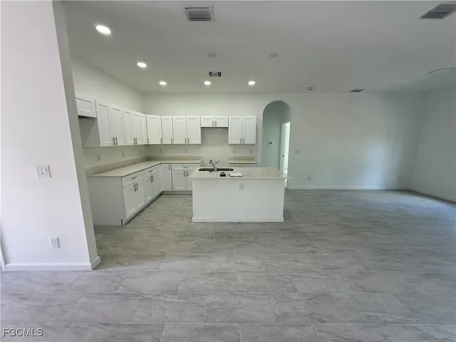 a kitchen with a sink cabinets and window