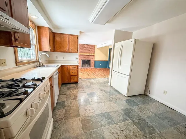 a kitchen with a stove sink and cabinets