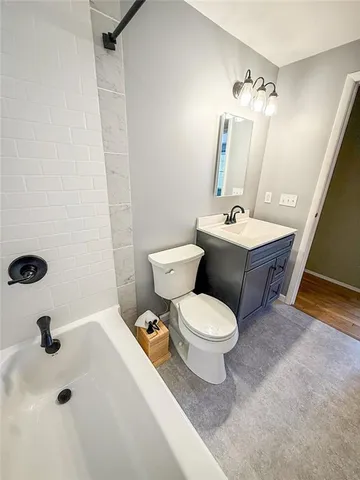 an empty room with wooden floor and a window