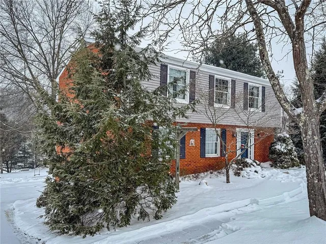 a front view of house with a garden