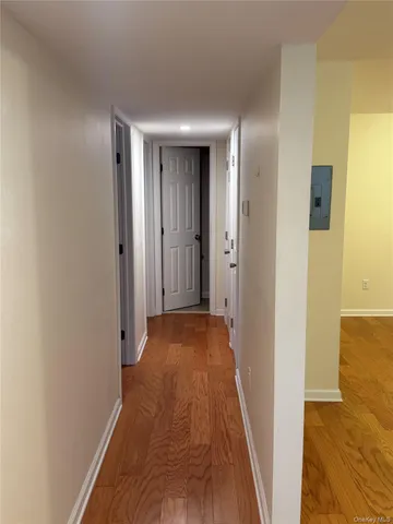 a view of a hallway with wooden floor