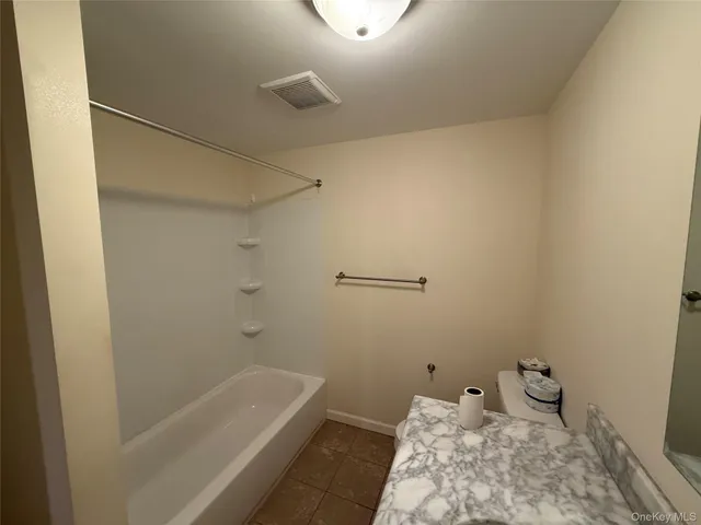 a bathroom with a bathtub and toilet