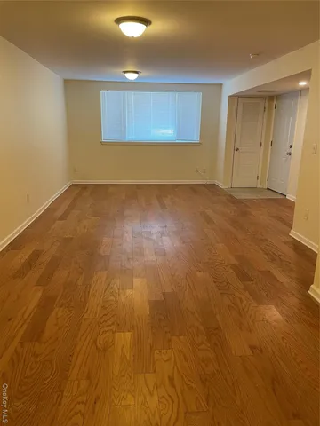 an empty room with wooden floor