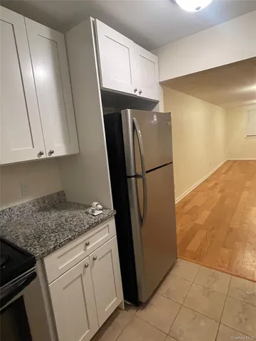 a kitchen with a refrigerator sink and cabinets