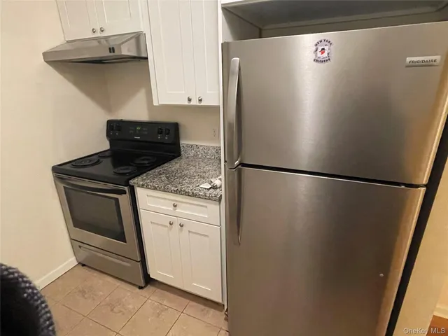 a kitchen with a refrigerator and a stove