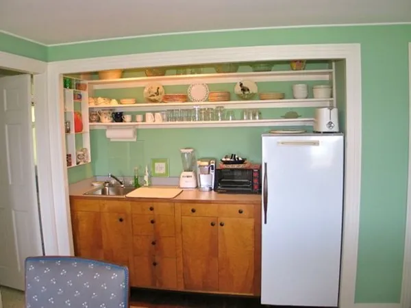 a room with a washing machine and cabinets