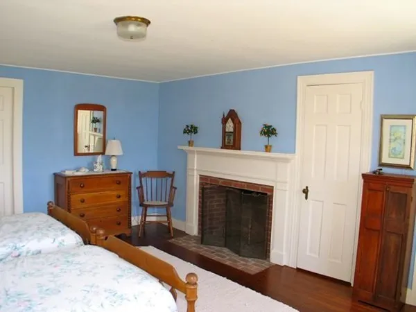 a bedroom with a bed and a fireplace